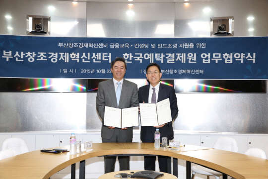 유재훈 한국예탁결제원 사장(왼쪽)과 조홍근 부산창조경제혁신센터 센터장이 업무협약 체결 후 기념촬영을 하고 있다.   한국예탁결제원 제공